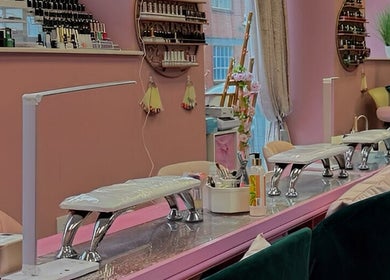 Elegant nail salon interior at Nails And The City London, Birmingham, England, GB with plush chairs and colorful decor.