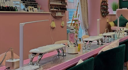 Elegant nail salon interior at Nails And The City London, Birmingham, England, GB with plush chairs and colorful decor.