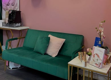 Stylish green seating area at Nails And The City London, Birmingham, England, GB with decor details.