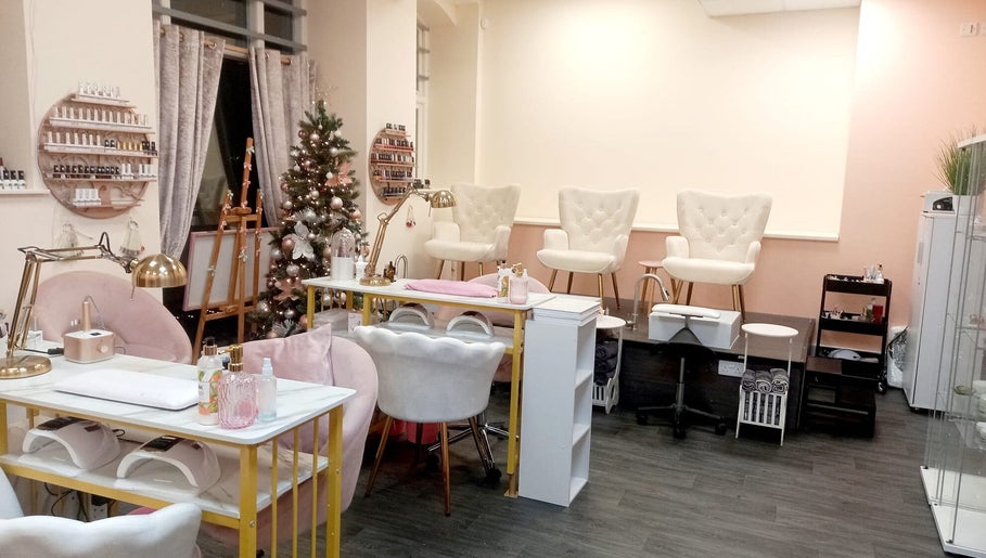 Chic interior of Myrto Zafeiropoulou spa in Birmingham, England, GB with white chairs and festive decor.