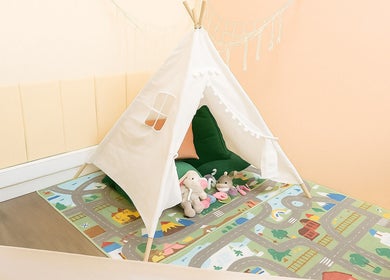 Charming teepee play area at Myrto Zafeiropoulou, Birmingham, England, GB with plush toys and colorful mat.