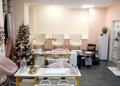 Elegant nail salon interior at Nails and the City, Birmingham, England, GB with festive decor and plush seating.