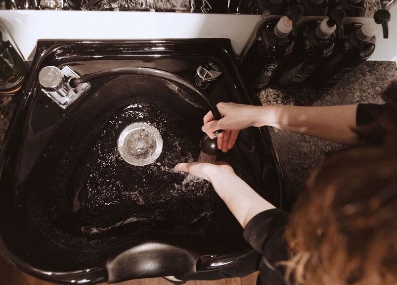 Hair washing station at Karen Giesbrecht Salon in Winkler, Manitoba, CA with luxurious products.