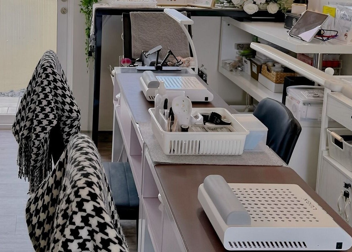 Elegant manicure setup at Diva Me At Thomson Rooftop, Singapore, SG, adorned with a stylish houndstooth throw.