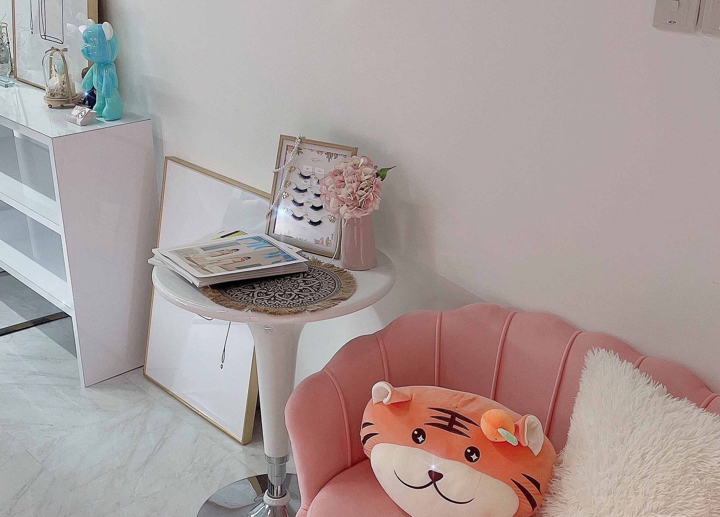 Chic seating area at Diva Me At Woodlands, Singapore, Singapore, SG with pink chair and plush decor.