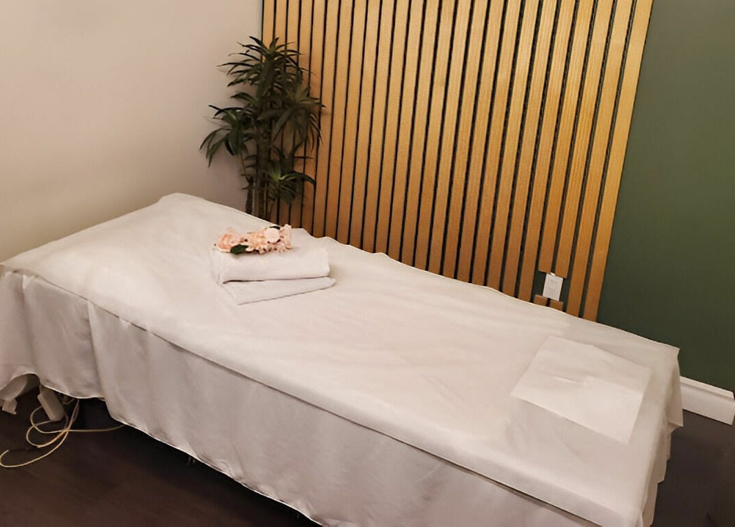 Serene massage room at Footscape Spa, Richmond Hill, Ontario, CA with a neatly arranged bed.