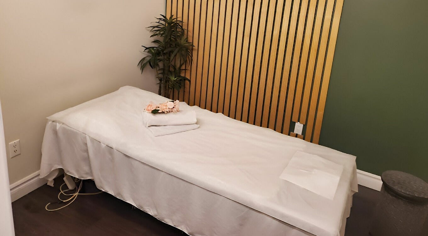 Serene massage room at Footscape Spa, Richmond Hill, Ontario, CA with a neatly arranged bed.