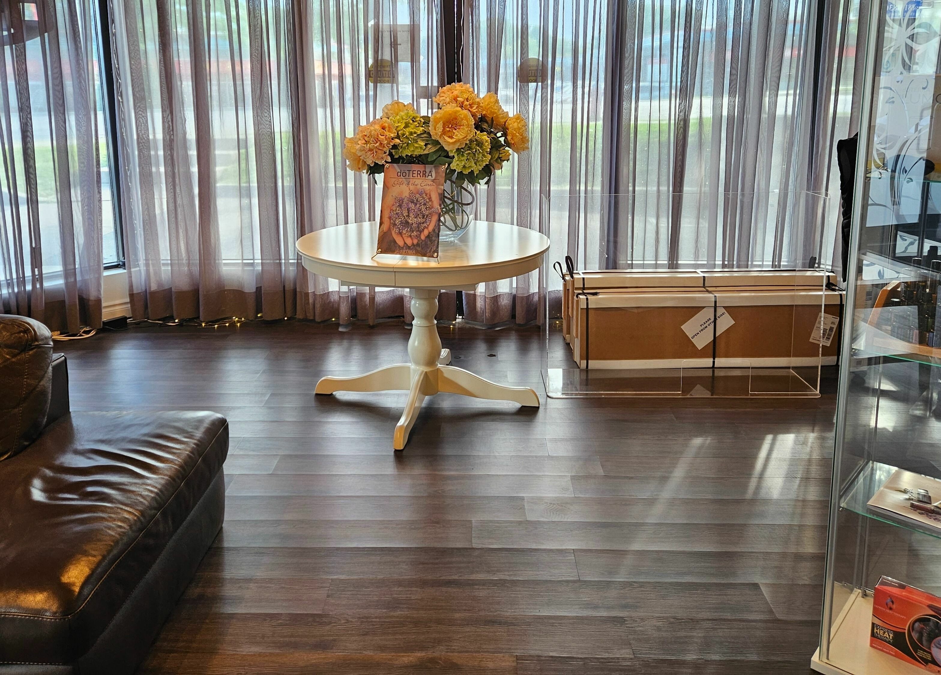 Elegant lobby at Footscape Spa in Richmond Hill, Ontario, CA, featuring a white table with flowers and luxury decor.