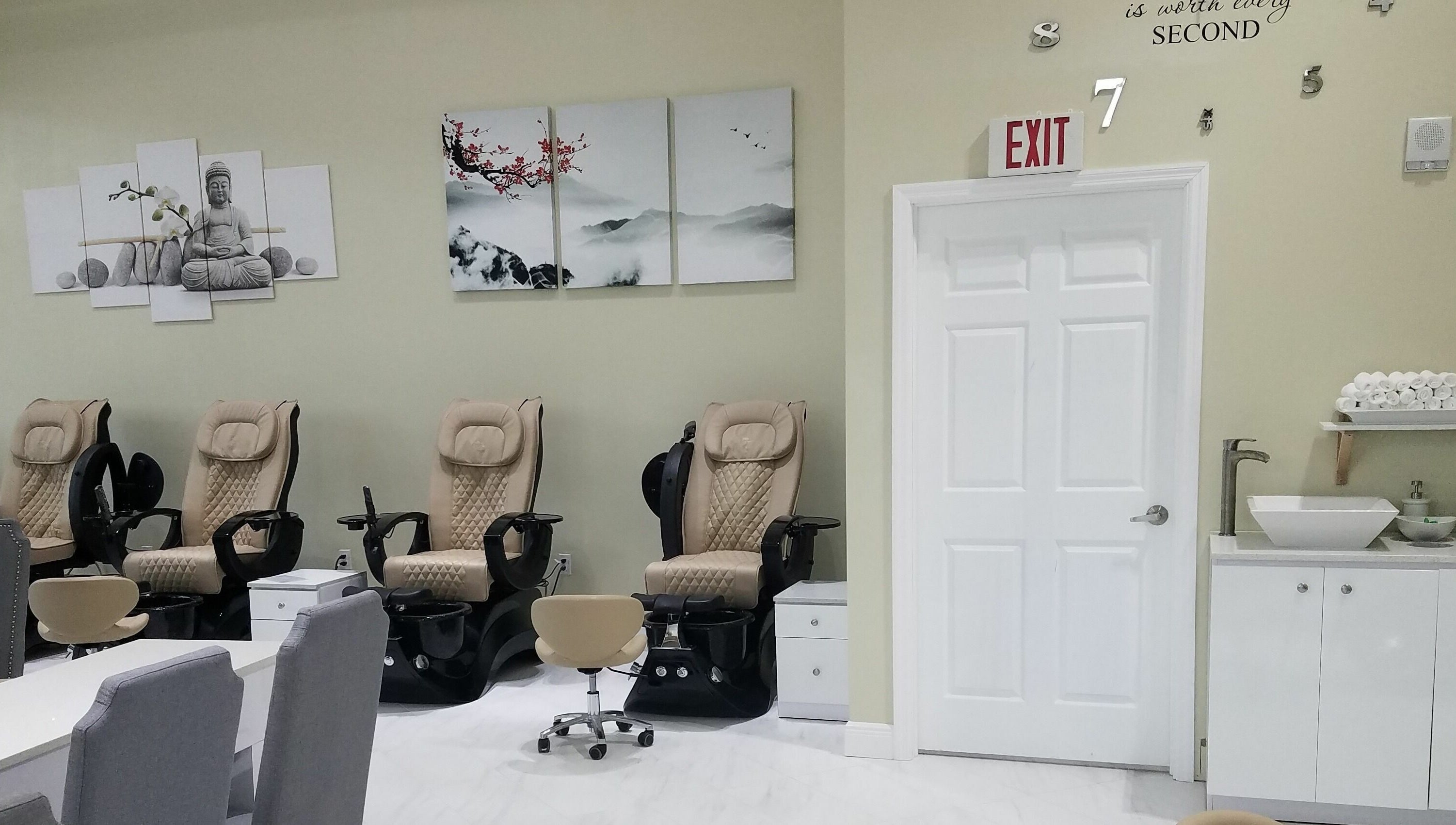 Relaxing pedicure chairs at The Nail Venue in Miami, Florida, US, with calming artwork and modern decor.