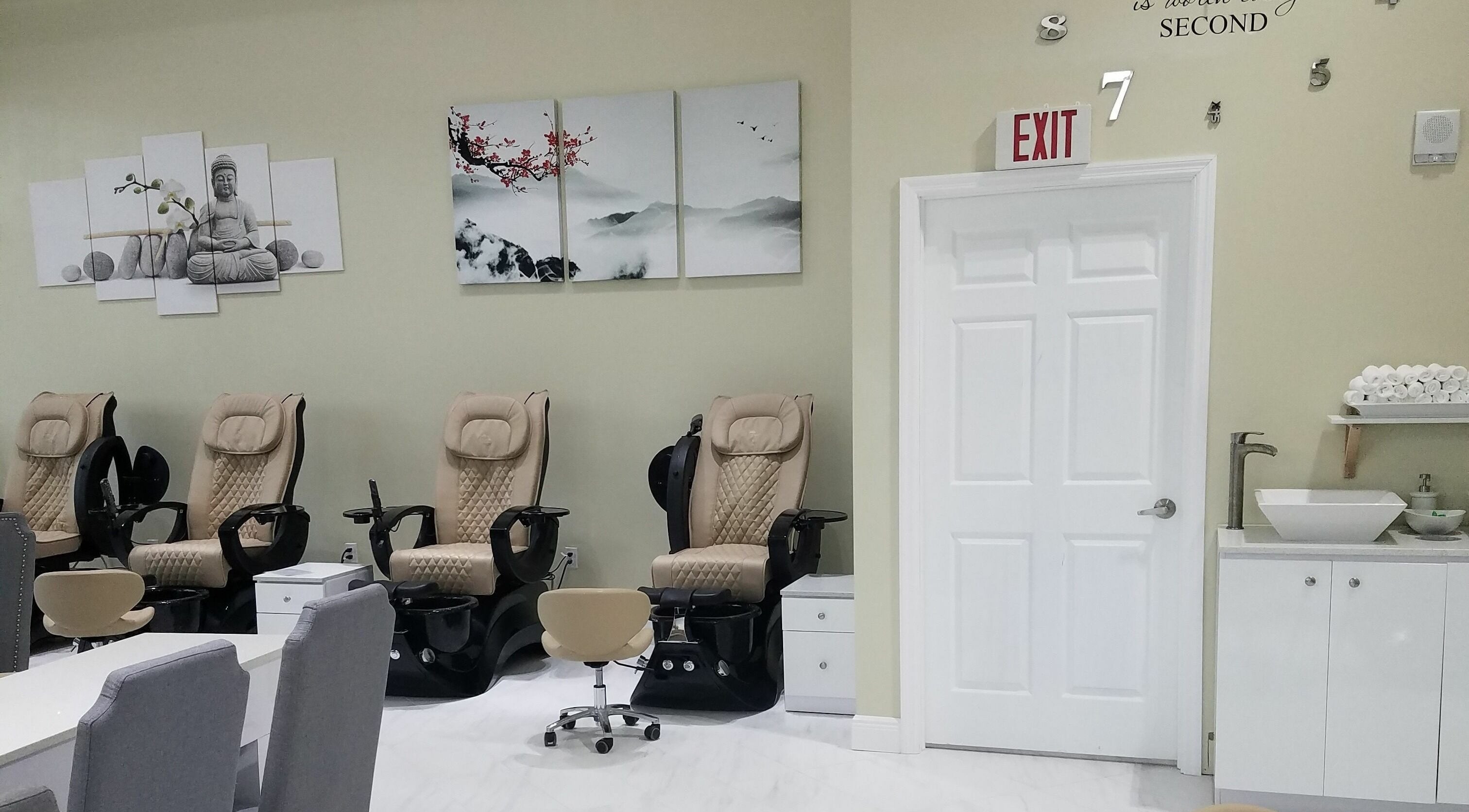 Relaxing pedicure chairs at The Nail Venue in Miami, Florida, US, with calming artwork and modern decor.
