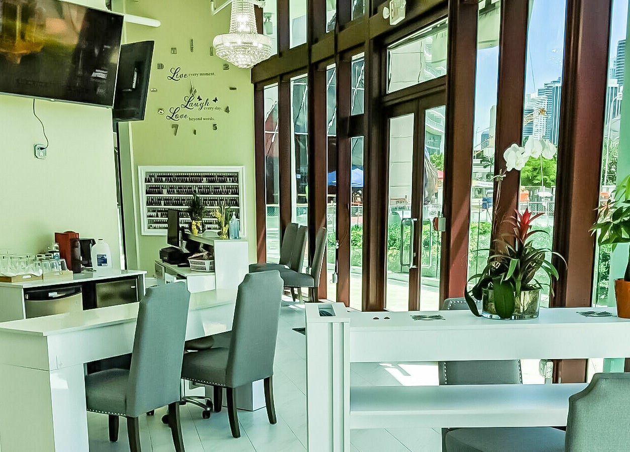 Interior view of The Nail Venue in Miami, Florida, US, showcasing elegant nail stations and vibrant decor.