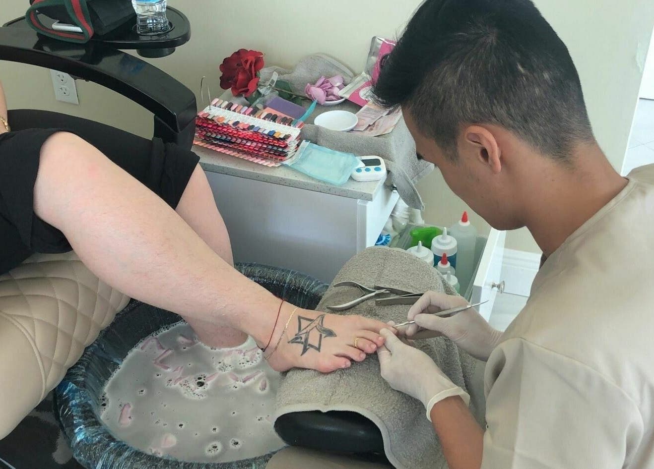 Pedicure session at The Nail Venue, Miami, Florida, US. A client receives relaxing foot care treatment.