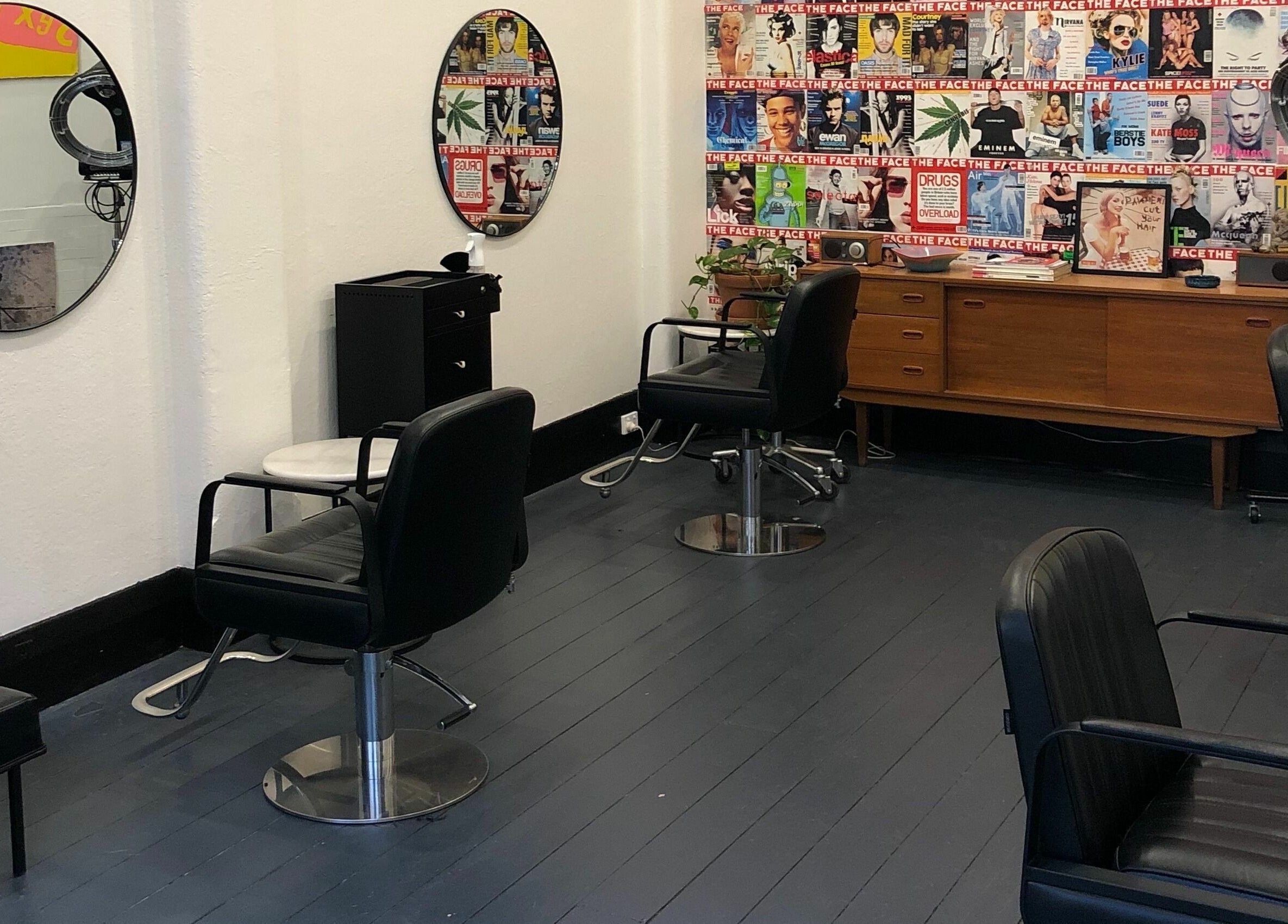 Chic salon interior at Paradise Cutters, Melbourne, Victoria, AU with vintage decor and stylish seating.