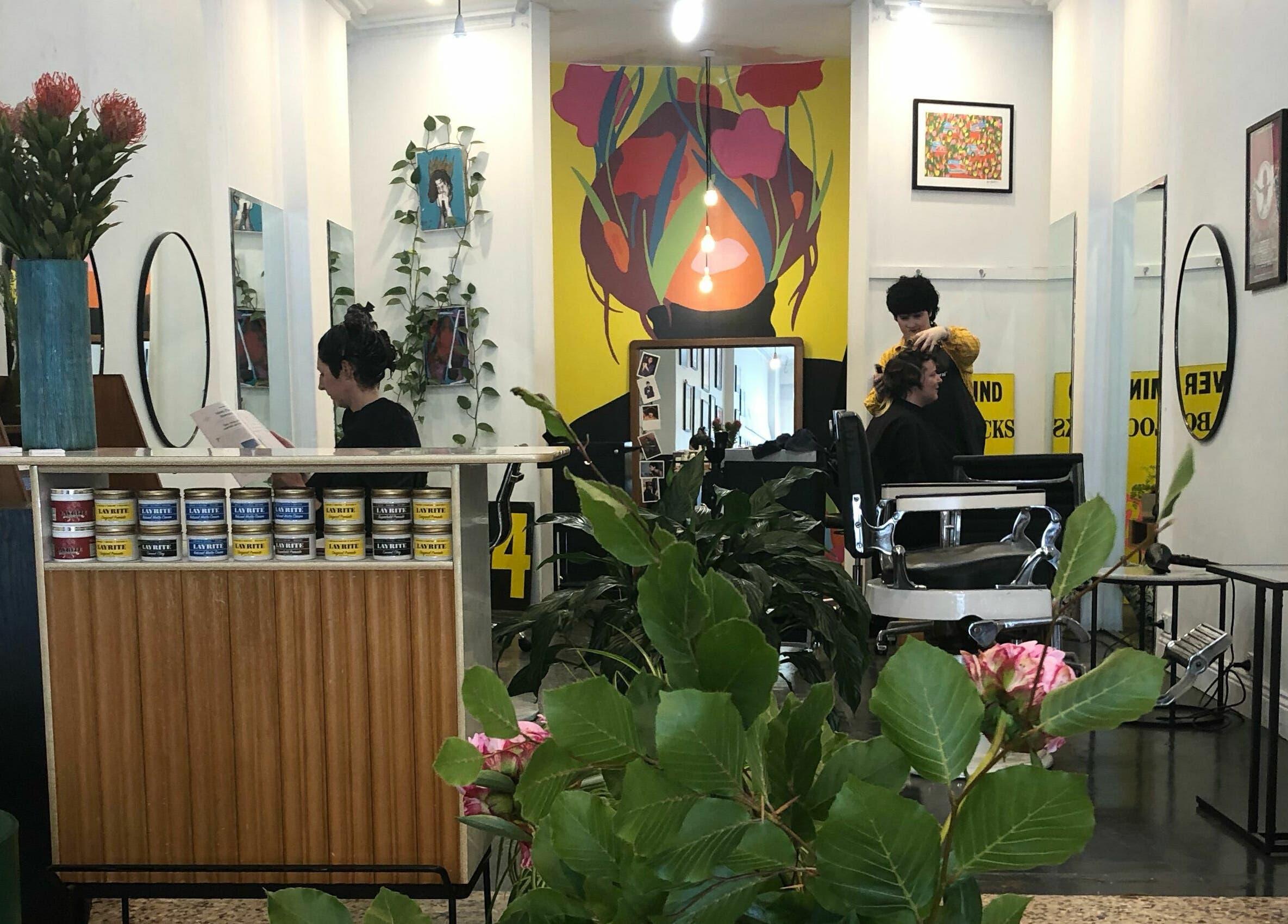 Chic interior of Paradise Cutters hair salon in Melbourne, Victoria, AU, showcasing vibrant decor and styling chairs.