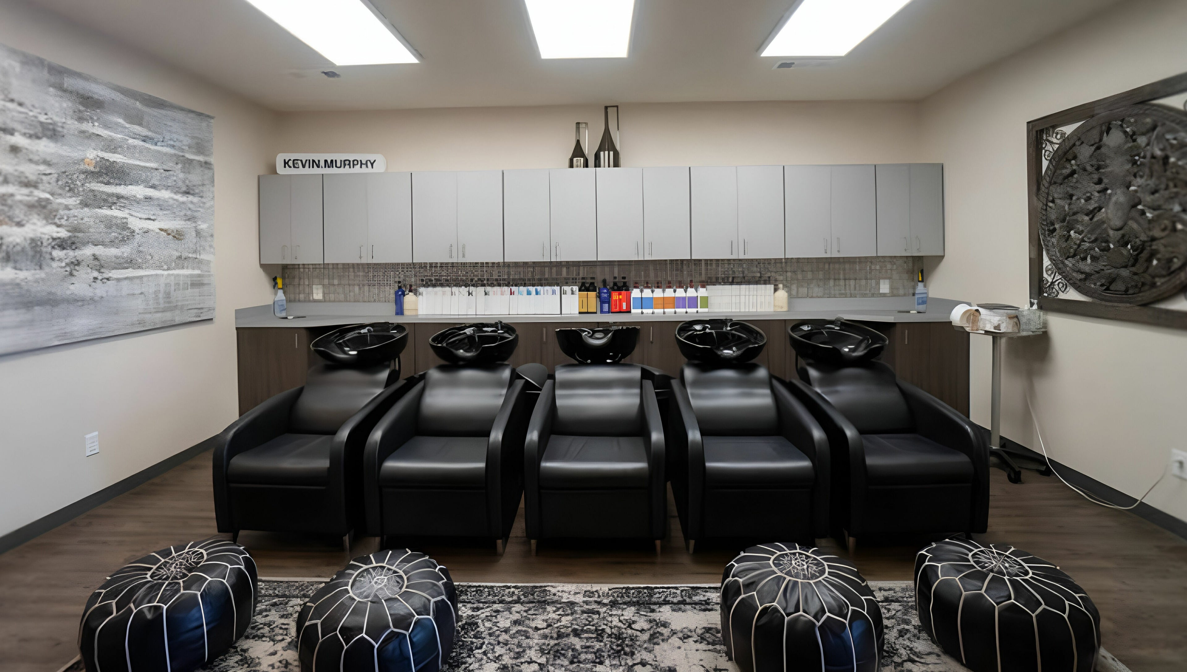 Luxurious wash station at Cheveux Salon in Hendersonville, Tennessee, US, featuring sleek black chairs.