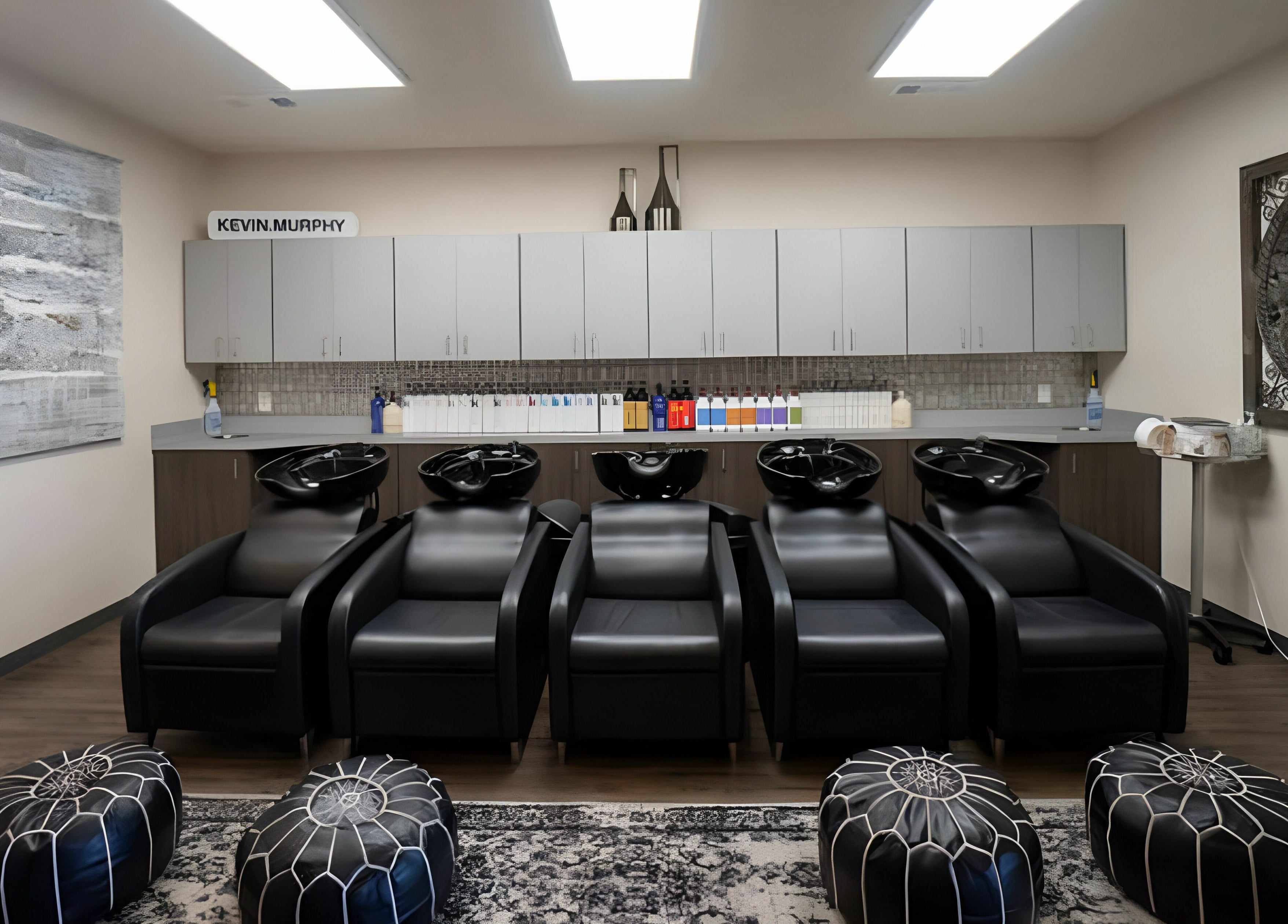 Luxurious wash station at Cheveux Salon in Hendersonville, Tennessee, US, featuring sleek black chairs.