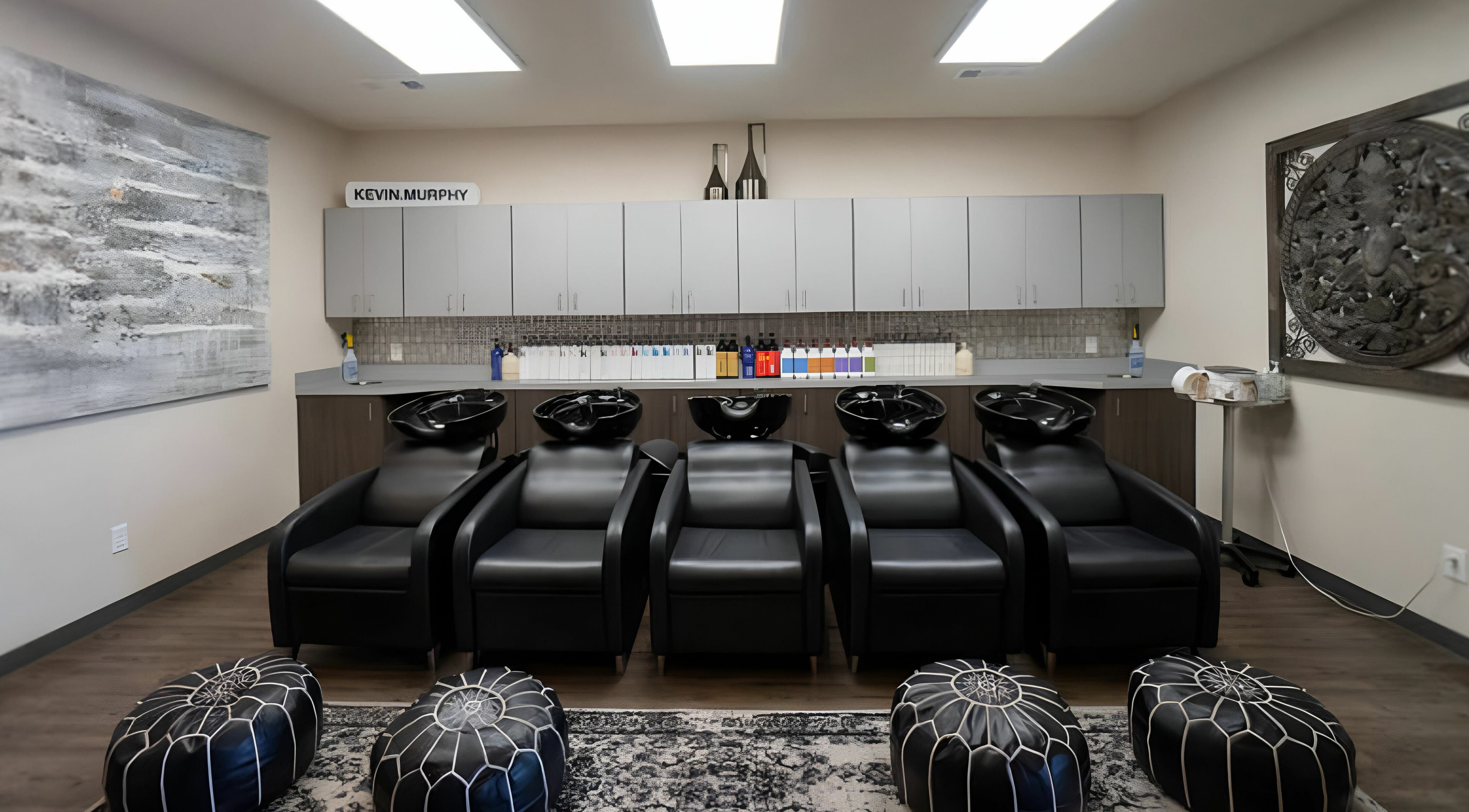 Luxurious wash station at Cheveux Salon in Hendersonville, Tennessee, US, featuring sleek black chairs.