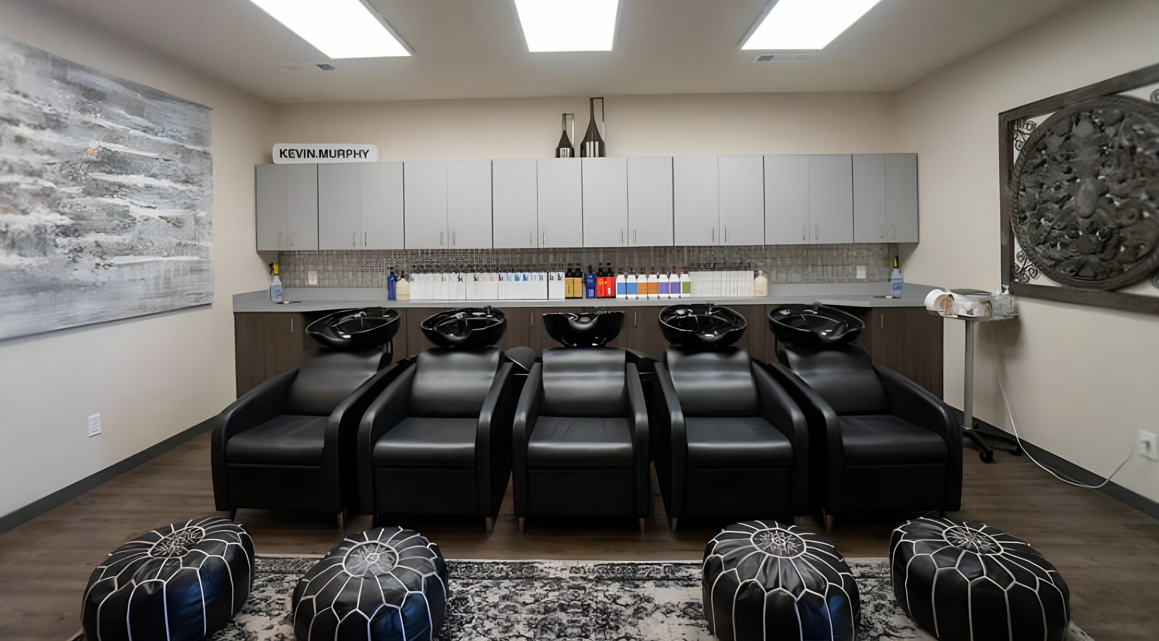 Luxurious wash station at Cheveux Salon in Hendersonville, Tennessee, US, featuring sleek black chairs.