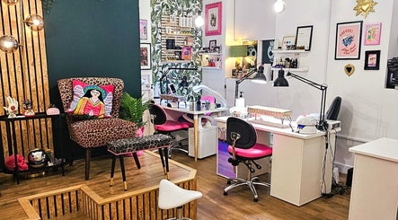 Vibrant interior of Offbeat Beauty Collective, Sheffield, England, GB, featuring colorful decor and nail workstations.