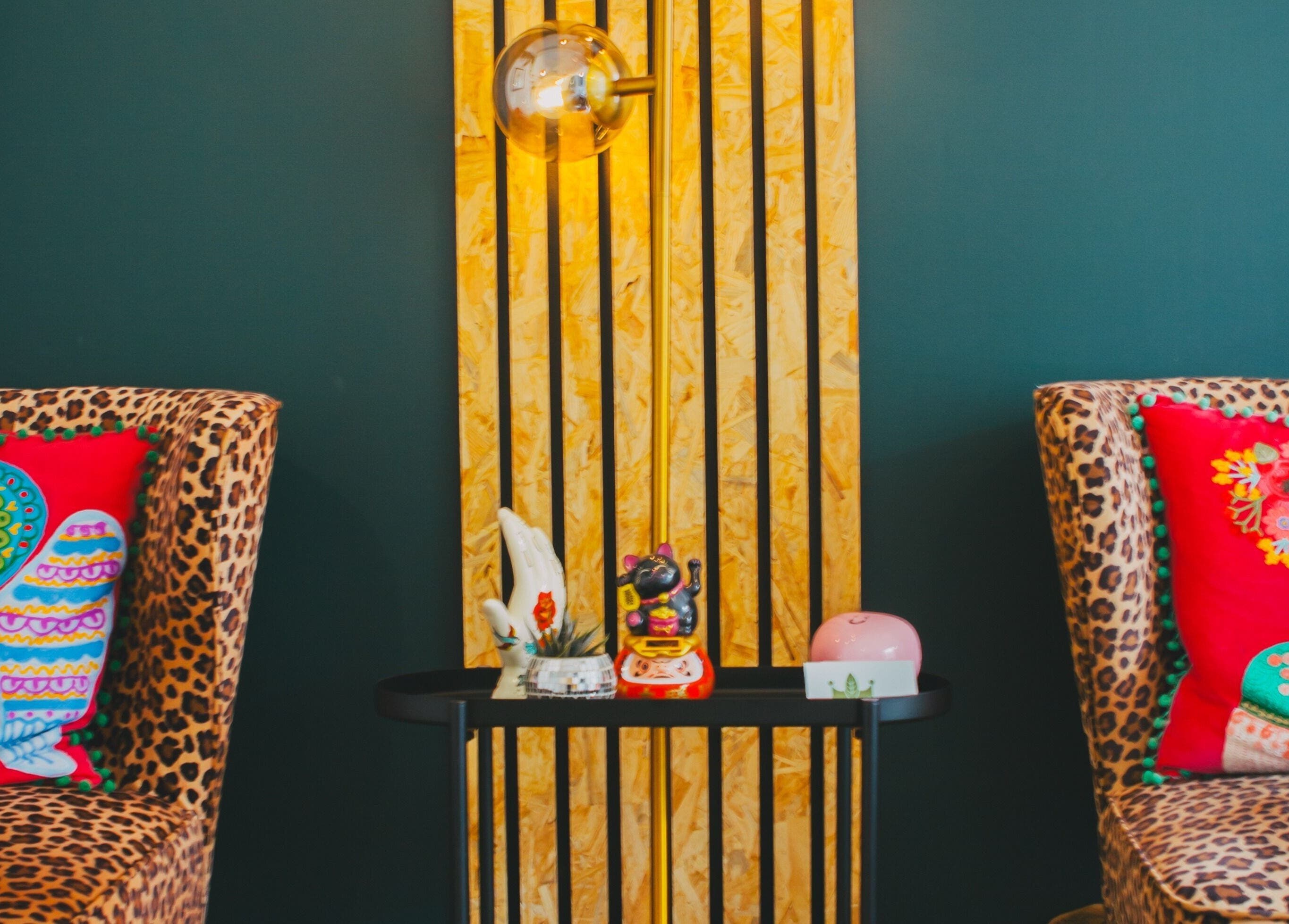 Vibrant seating at Offbeat Beauty Collective, Sheffield, England, GB with colorful cushions and decor.