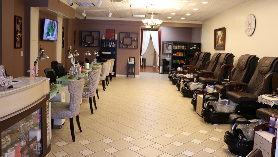 Spacious and elegant interior of The Nail Retreat Dublin, Ohio, US with plush chairs and nail stations.