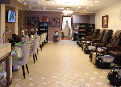 Spacious and elegant interior of The Nail Retreat Dublin, Ohio, US with plush chairs and nail stations.