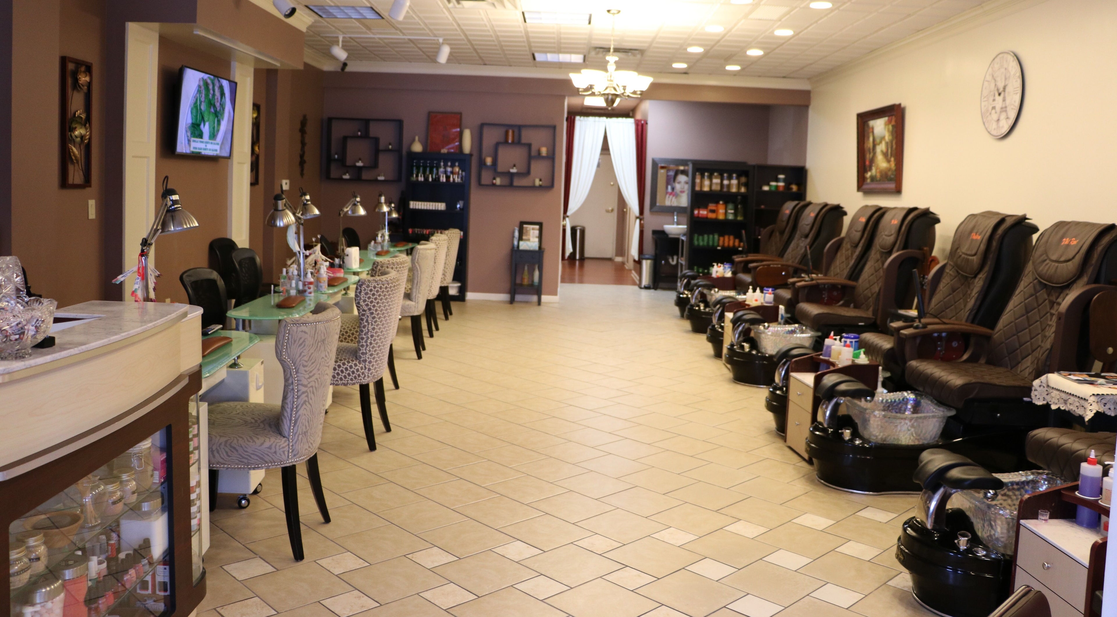 Spacious and elegant interior of The Nail Retreat Dublin, Ohio, US with plush chairs and nail stations.