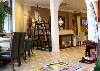 Relaxing interior of The Nail Retreat Dublin with plants and seating in Dublin, Ohio, US.