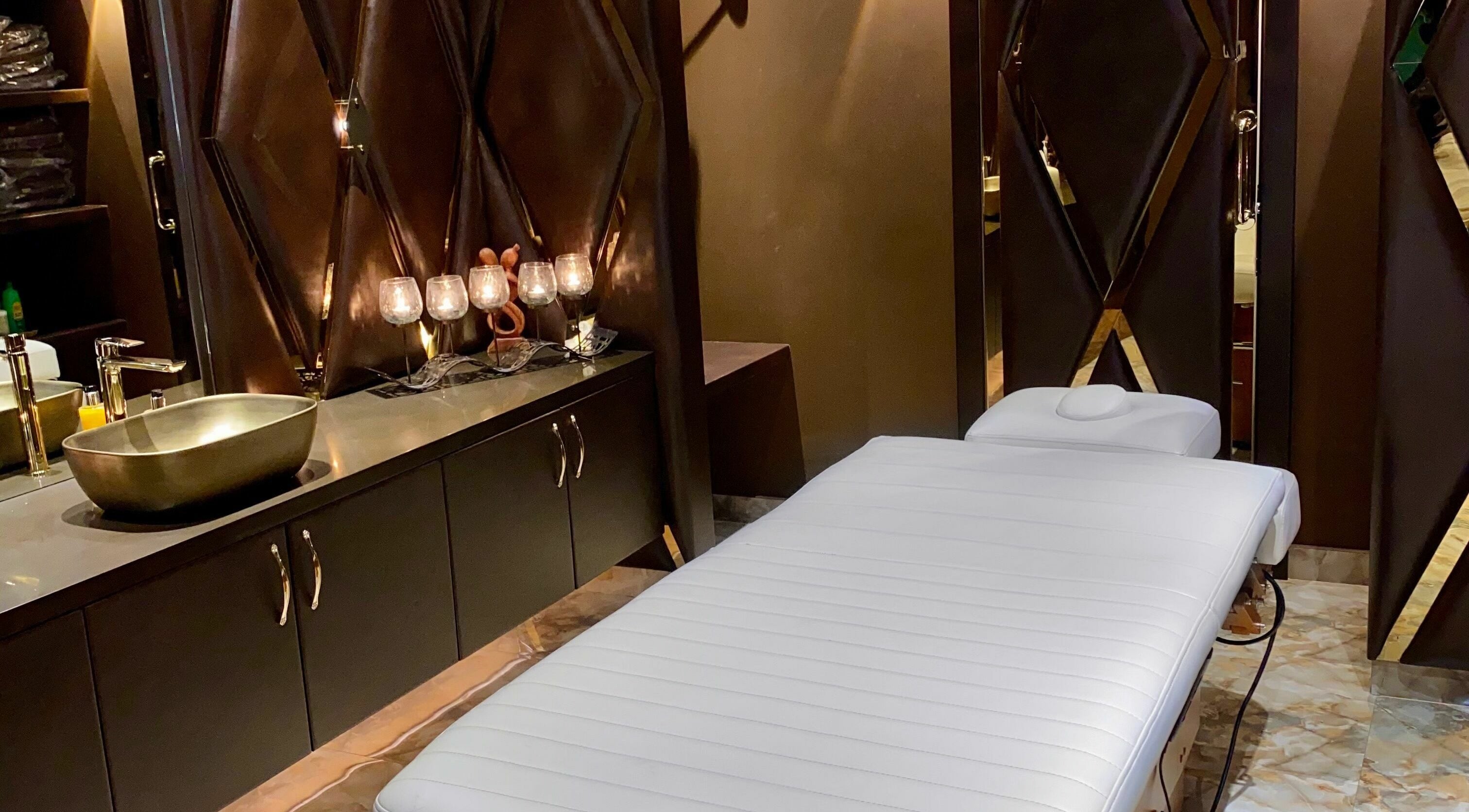 Lavish treatment room at Lavana Spa - Grand Excelsior Hotel Al Barsha, Dubai, Dubai, AE with a massage table.