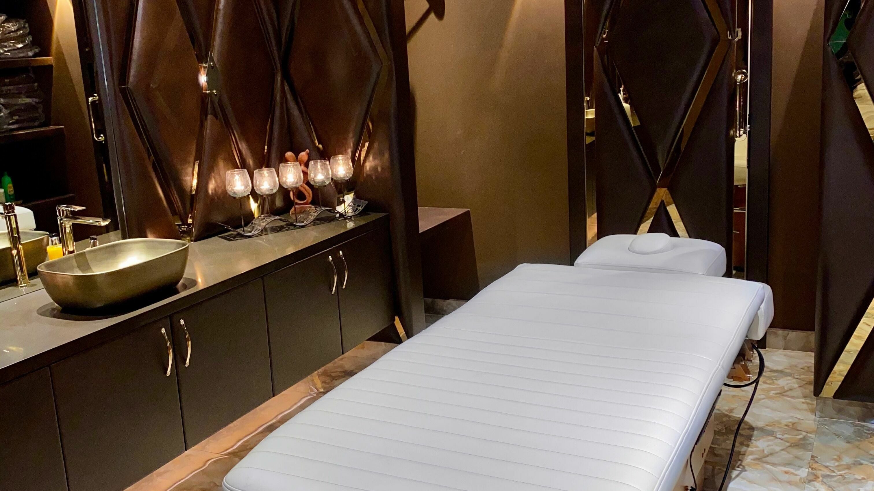 Lavish treatment room at Lavana Spa - Grand Excelsior Hotel Al Barsha, Dubai, Dubai, AE with a massage table.