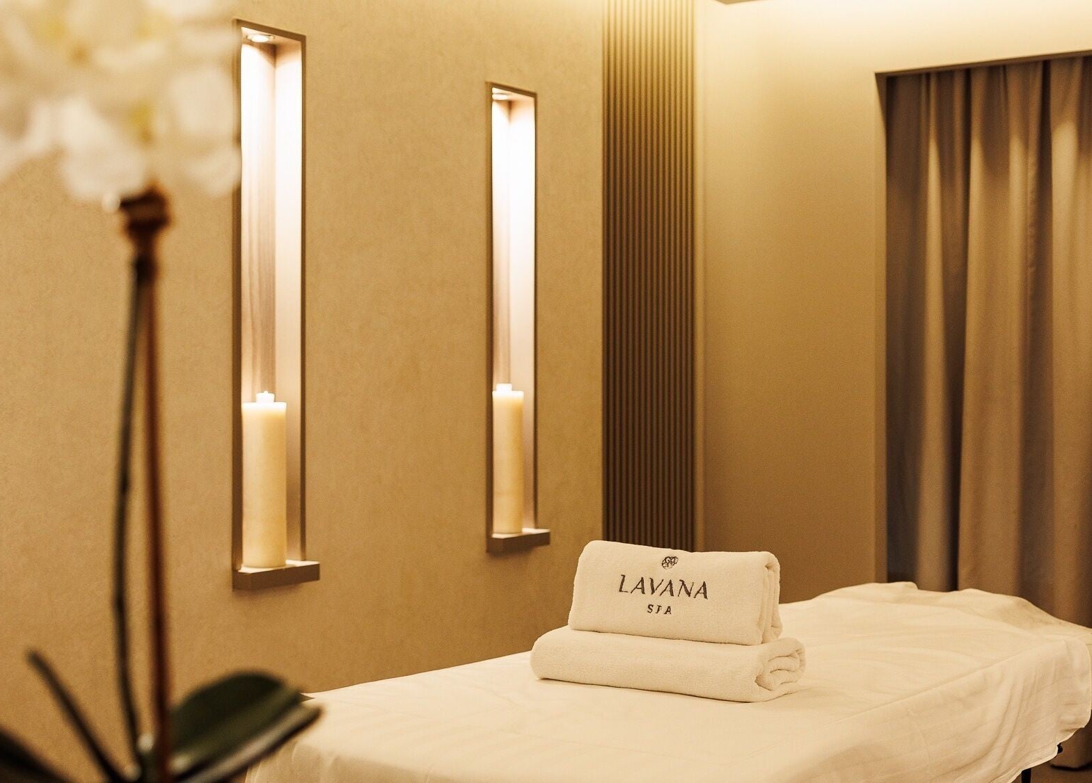 Serene spa room at Lavana Spa - DIFC, Dubai, Dubai, AE with soft lighting and plush white towels.