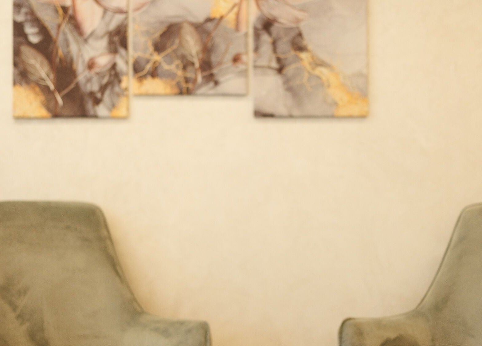 Two plush chairs in Lavana Spa - DIFC, Dubai, Dubai, AE, with abstract art on the wall.