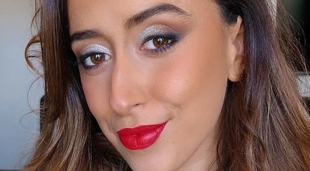 Woman with striking red lipstick and shimmering eyeshadow at Rebekah Nails and Make Up, Is-swieqi, MT.