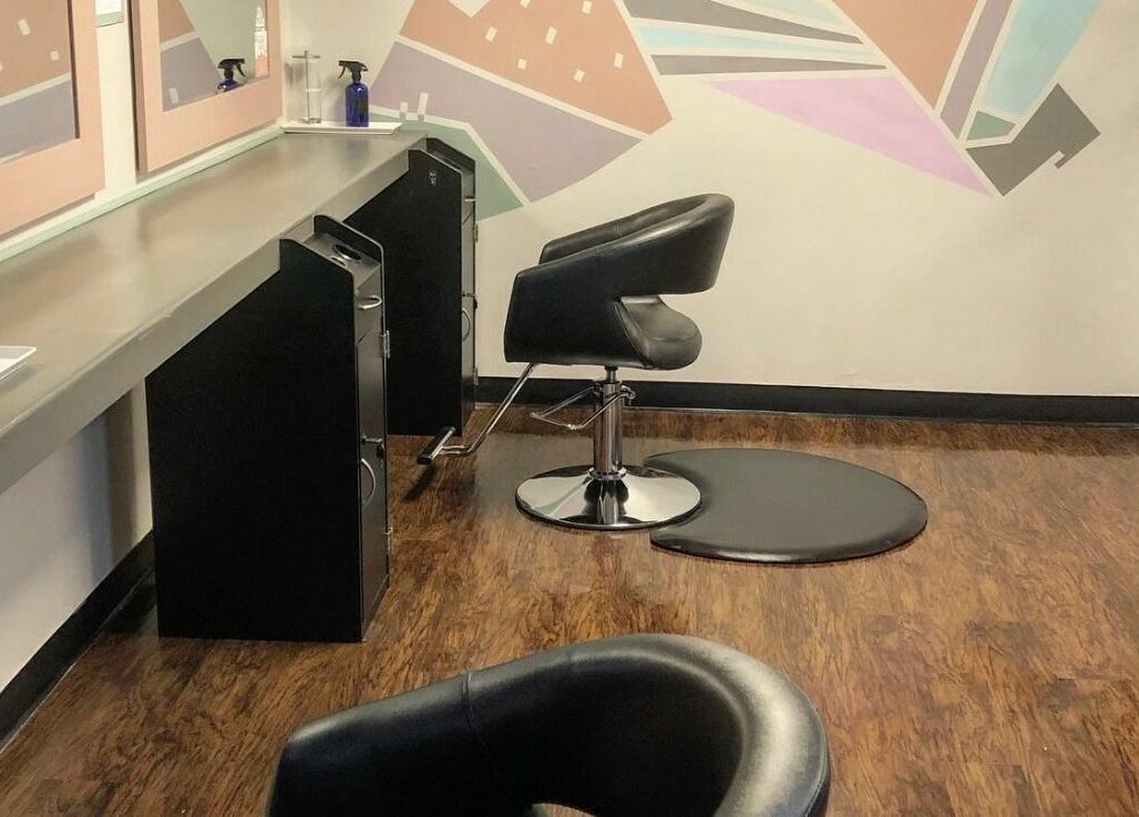 Modern styling area at The Grey Rose Salon in Dallas, Pennsylvania, US with sleek chairs and vibrant wall art.