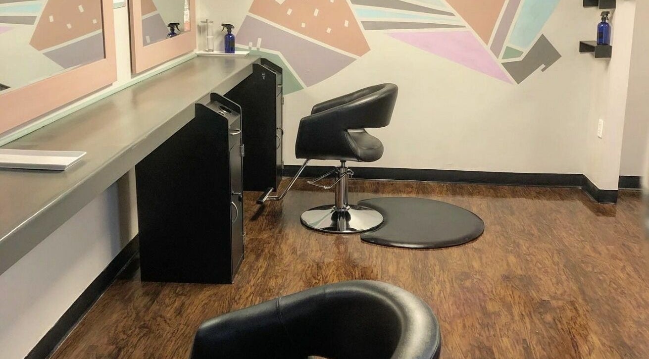 Modern styling area at The Grey Rose Salon in Dallas, Pennsylvania, US with sleek chairs and vibrant wall art.