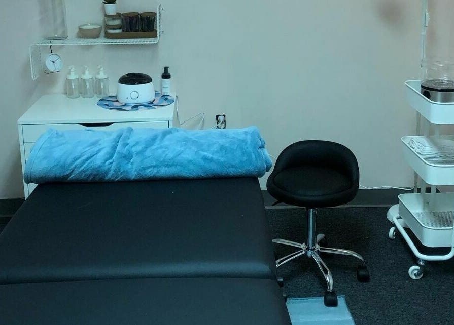 Tranquil treatment room at The Grey Rose Salon in Dallas, Pennsylvania, US, featuring a comfy massage table.