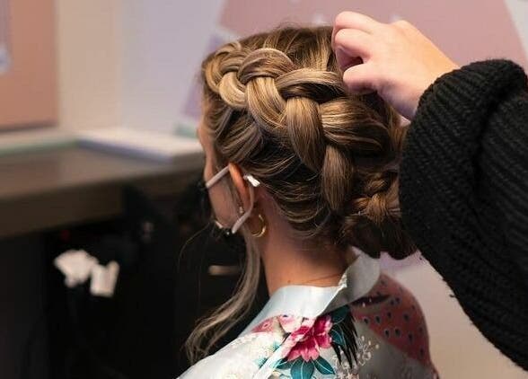 Stylist creates an elegant braid at The Grey Rose Salon in Dallas, Pennsylvania, US.
