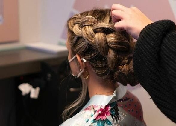 Stylist creates an elegant braid at The Grey Rose Salon in Dallas, Pennsylvania, US.