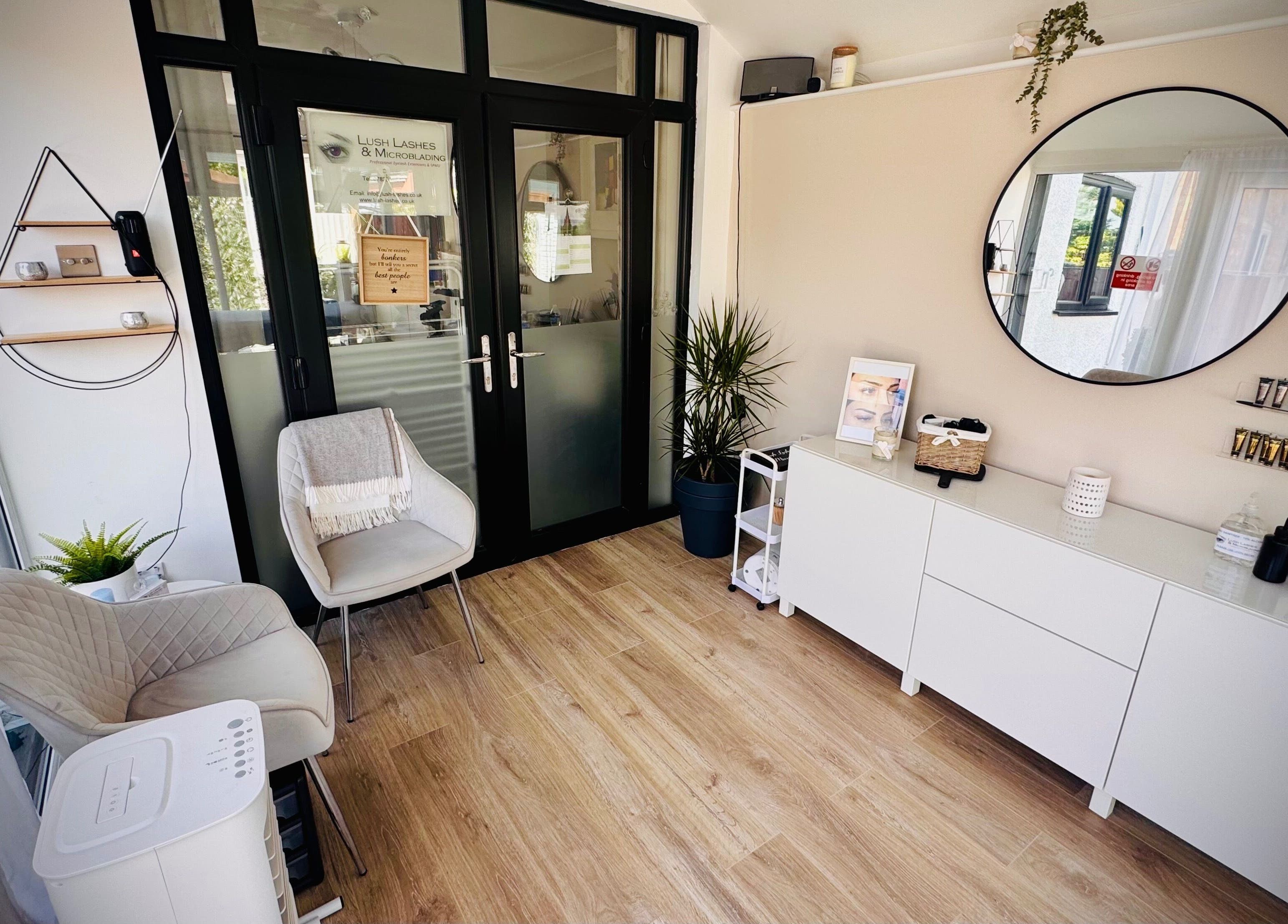 Inviting interior of Lush Lashes & Microblading, Ellesmere Port, England, showcasing modern decor and comfy seating.