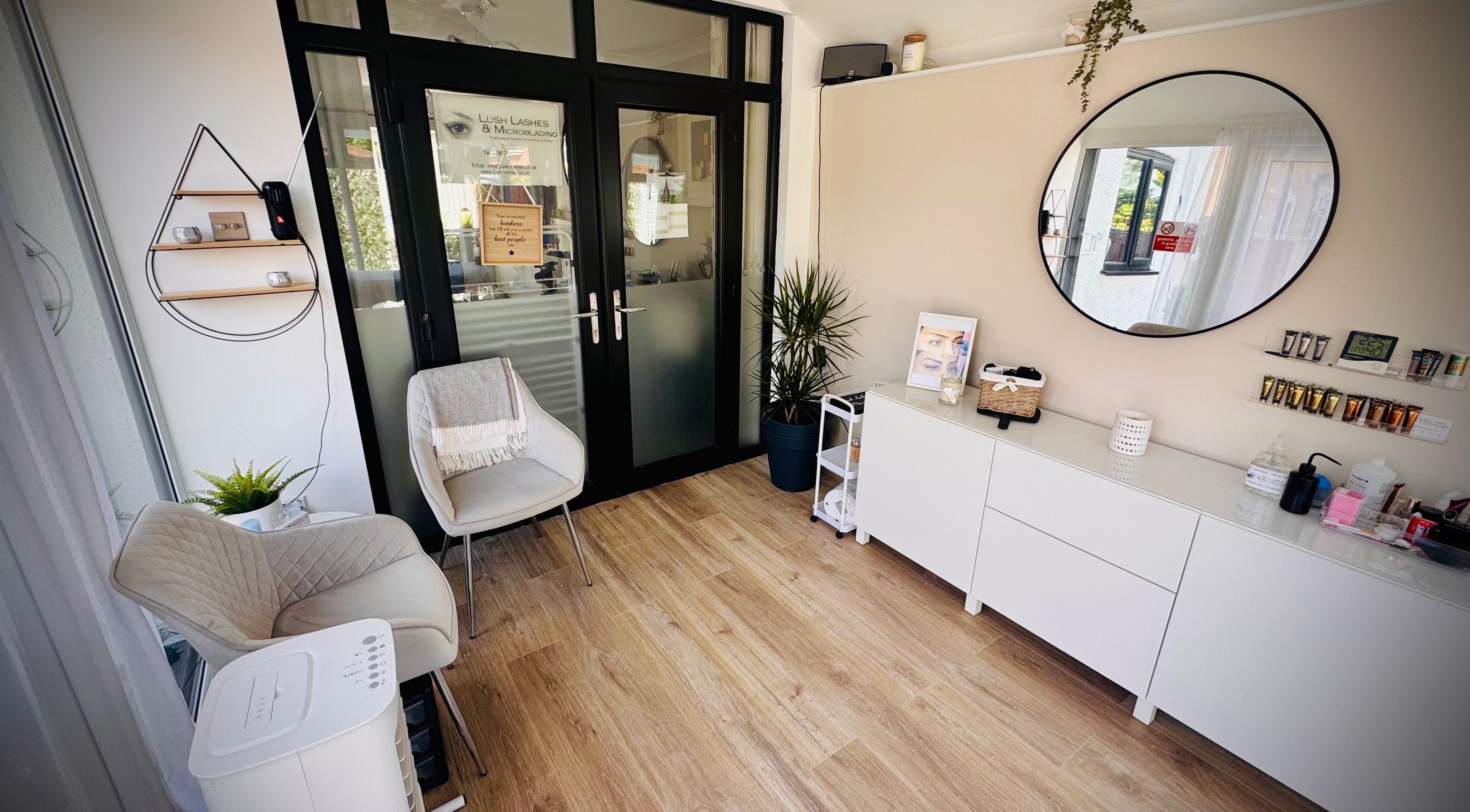 Inviting interior of Lush Lashes & Microblading, Ellesmere Port, England, showcasing modern decor and comfy seating.