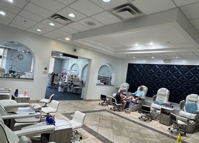 Relaxing nail salon interior at Nailistix, West Bloomfield Township, Michigan, US with modern white chairs.