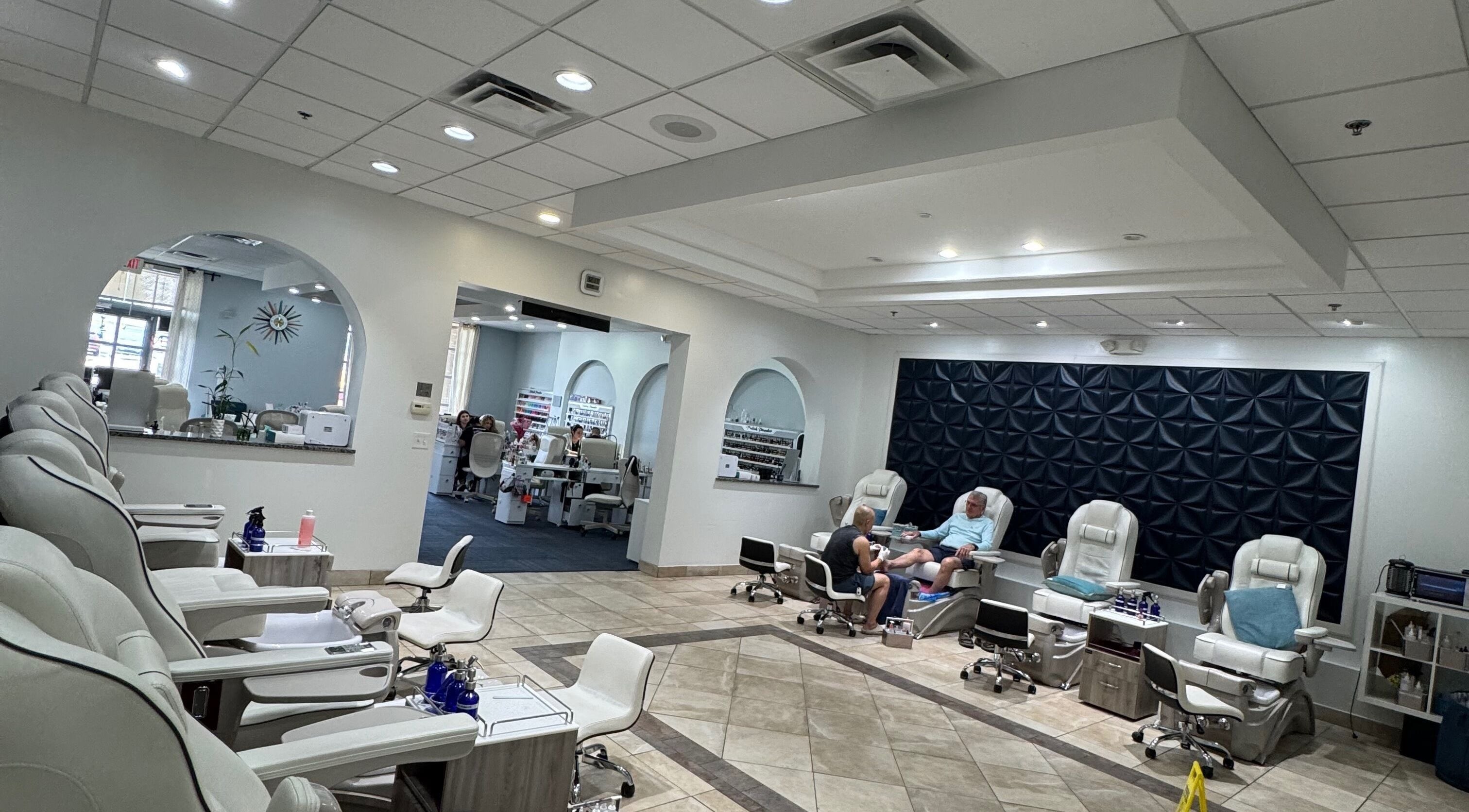 Relaxing nail salon interior at Nailistix, West Bloomfield Township, Michigan, US with modern white chairs.