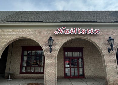 Nailistix salon entrance with arched brick facade in West Bloomfield Township, Michigan, US.