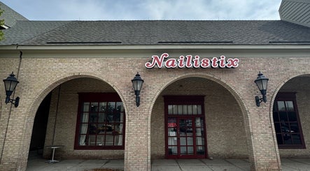 Nailistix salon entrance with arched brick facade in West Bloomfield Township, Michigan, US.
