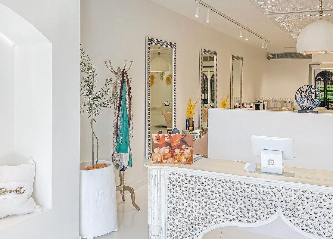 Chic reception at Jacob Zinsli Salon, Surfers Paradise, Queensland, AU with decorative mirrors and cozy seating.