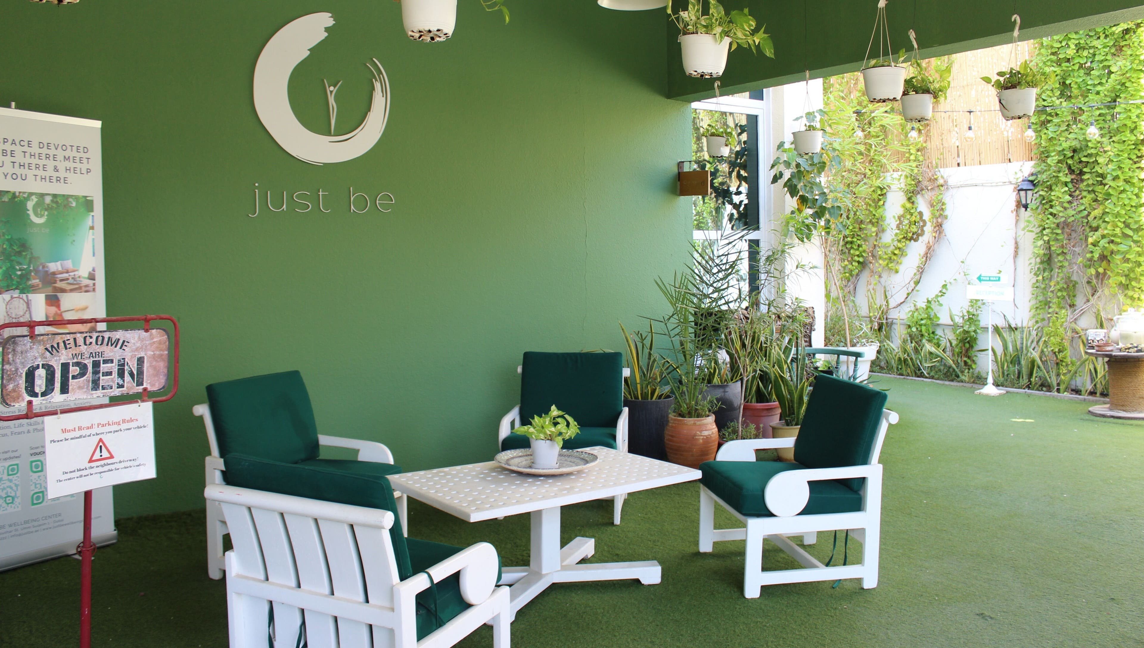 Cozy green lounge at I Am More, Dubai, Dubai, AE, featuring elegant seating and lush plants.