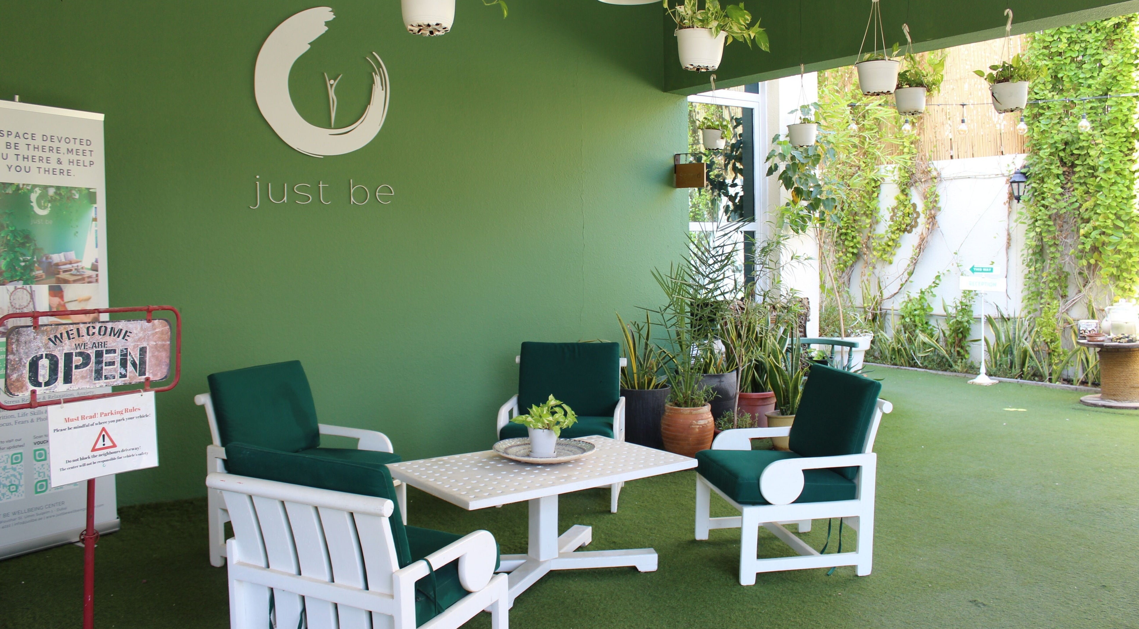 Cozy green lounge at I Am More, Dubai, Dubai, AE, featuring elegant seating and lush plants.