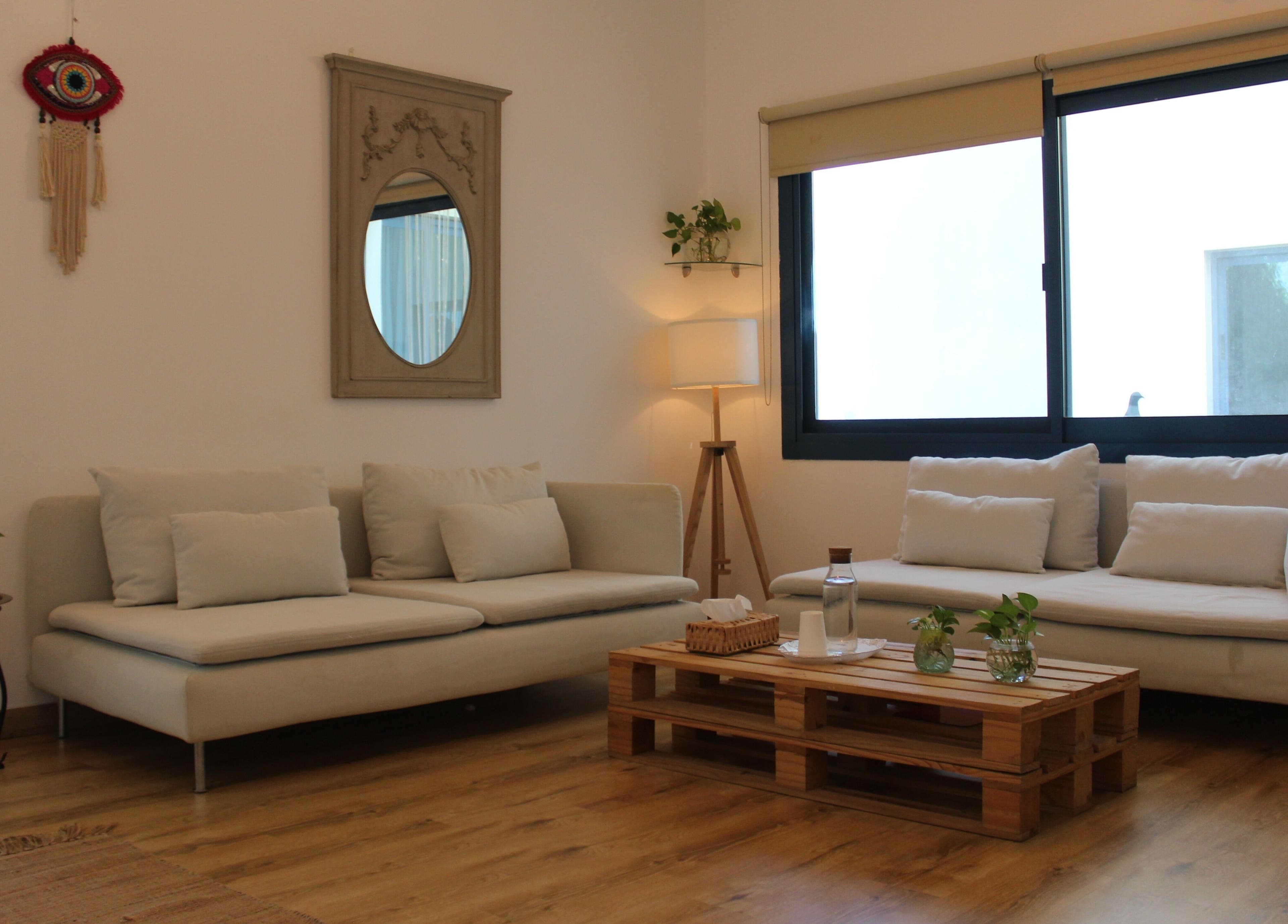 Cozy lounge with sofas at I Am More, Dubai, Dubai, AE featuring minimalist decor and natural light.