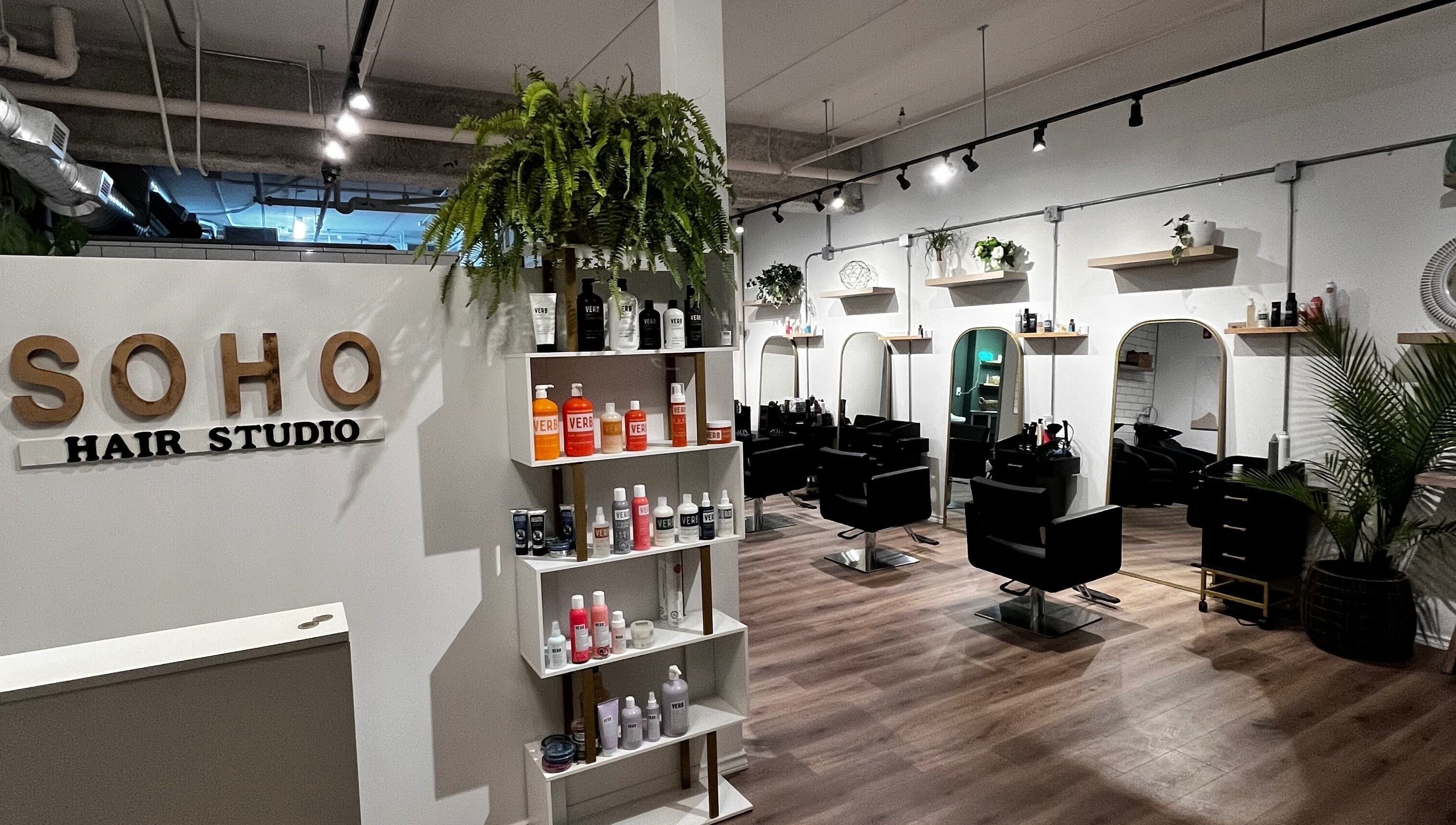 Inside Hair By Jordyn in Windsor, Ontario, CA, stylish chairs and products create a modern beauty salon atmosphere.