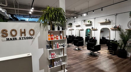 Inside Hair By Jordyn in Windsor, Ontario, CA, stylish chairs and products create a modern beauty salon atmosphere.